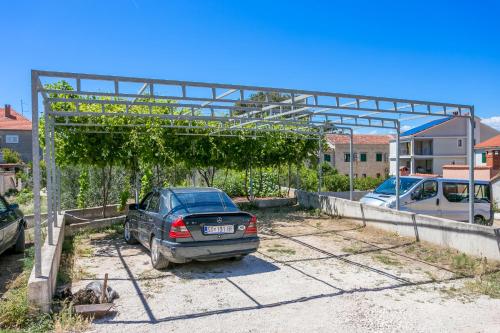 a car is parked in a parking lot at Double Room Supetar 5658d in Supetar