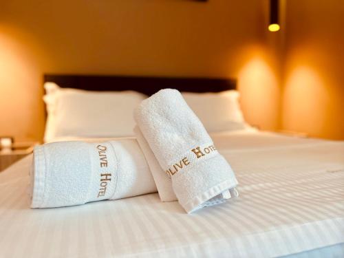two towels on a bed in a hotel room at Hotel Olive in Vlorë