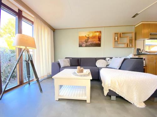 a living room with a couch and a table at Edelhert in Hulshorst