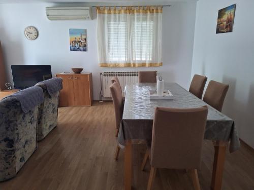 a dining room with a table and chairs at Apartments with parking space Supetarska Draga - Donja, Rab - 15999 in Rab
