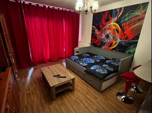 a room with a bed and a red curtain at MONFas APARTMENT GARDEN CITY in Prague