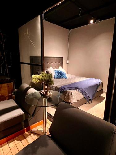a room with a bed and a couch and a table at Eco Lodge Glamping in Guatapé