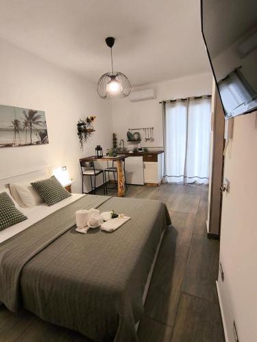 a bedroom with a bed and a table in a room at Casa vacanze green house in Terrasini