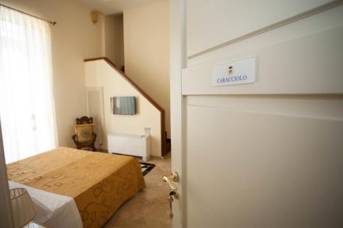 a bedroom with a bed and a door with a sign on it at B&B Nel Regno di Napoli in Naples