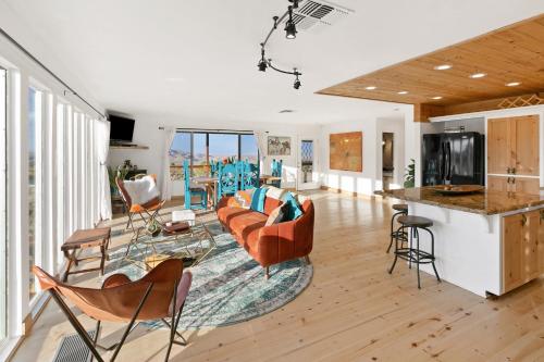 a living room with a couch and a table at High View Haven - Hot Tub, Fire Pit, BBQ in Joshua Tree! home in Joshua Tree