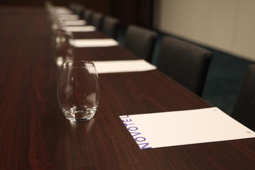 a row of wine glasses on a table with a napkin at Novotel Melbourne Airport in Melbourne