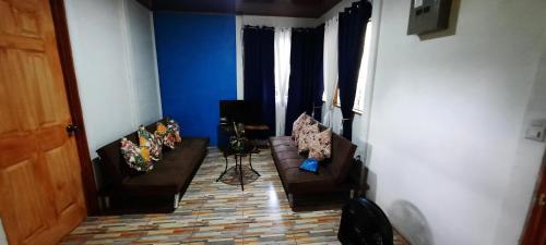 a living room with two couches and a television at Hospedaje Valencia Osa, CR in Potrero