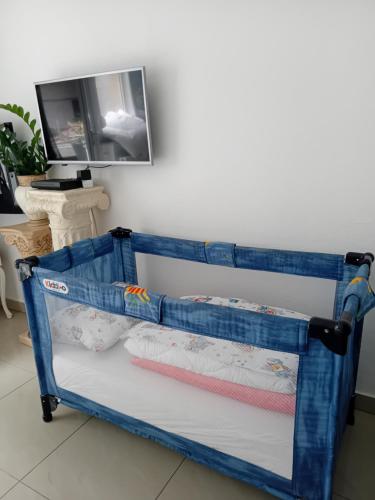 a blue crib bed frame in a room at Apartment Top Centar in Banja Luka