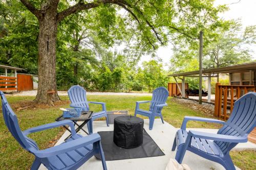 a group of blue chairs around a tree at Quaint and quiet Columbus Ga stay in Columbus