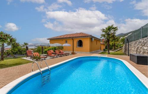 a swimming pool in front of a house at Nice Home In Opric With Wifi in Opric