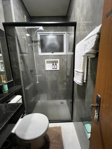 a bathroom with a shower and a toilet at Loft Home Vila Bella in Cuiabá