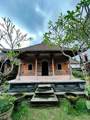 an orange building with steps in front of it at Homestay D'BANDEM in Penginyahan