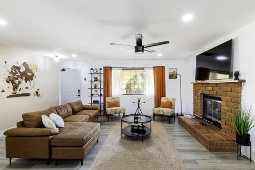 a living room with a couch and a fireplace at Sky Harbor House - Centrally Located withHot Tub home in Yucca Valley