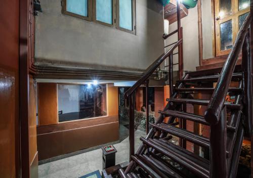 a staircase in a building with a person taking a picture at Munnar Bethel Varkis Heritage Resort in Munnar