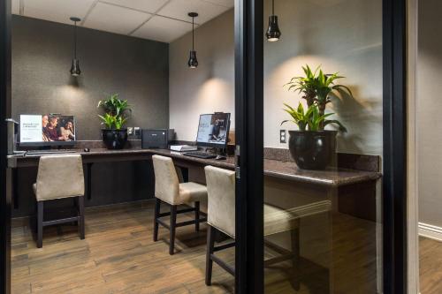 an office with a desk with two computers and chairs at Residence Inn by Marriott Las Vegas Hughes Center in Las Vegas