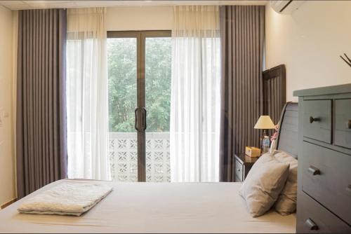 Postel nebo postele na pokoji v ubytování Trang Trại Gia Trịnh