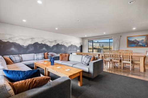 a living room with couches and a dining room at Tasman Holiday Parks - Te Anau in Te Anau