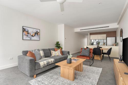 a living room with a couch and a table at The Alta Apartments by Urban Rest in Sydney