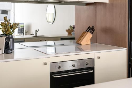 a kitchen with a black and white stove top oven at The Alta Apartments by Urban Rest in Sydney