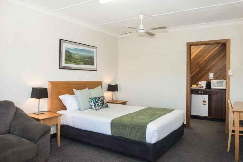a hotel room with a bed and a couch at Murwillumbah Motor Inn in Murwillumbah