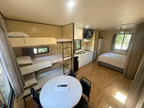 a small room with two bunk beds and a table at 1770 Holiday Village in Seventeen Seventy