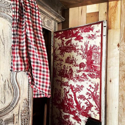 a cloth hanging on a wall next to a painting at AU LIT ON DORT - Logis de Village in Bellême