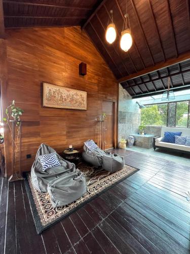 a living room with two bean bags on the floor at Harvest Palace Munduk in Munduk