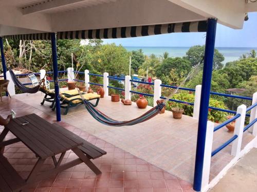 a porch with hammocks and a view of the ocean at Casa de playa Shangrilá in Las Palmeras