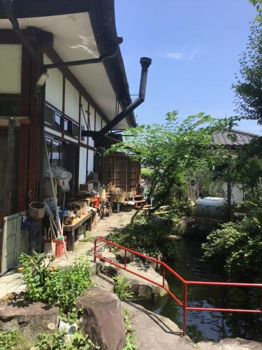 a building with a river in front of it at COZY Inn Free Shuttle service in Nikko