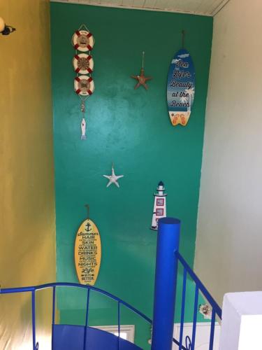 a room with a blue and green wall with signs on it at Casa de playa Shangrilá in Las Palmeras