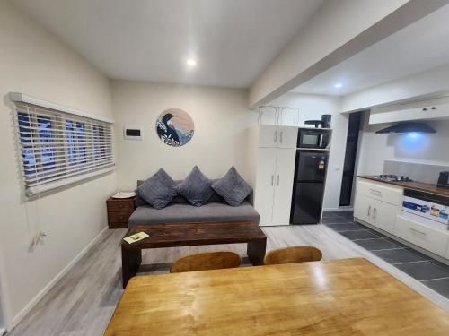 a kitchen with a couch and a table in a room at Thames River Valley Retreat Residence 1 in Thames