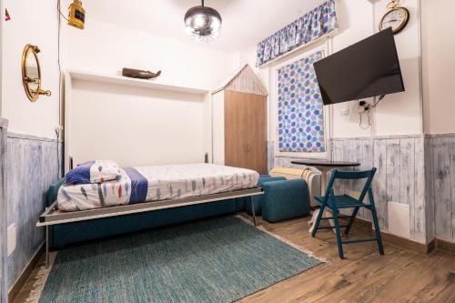 a bedroom with a bed and a table and a chair at LA VECCHIA MARINA in Rapallo