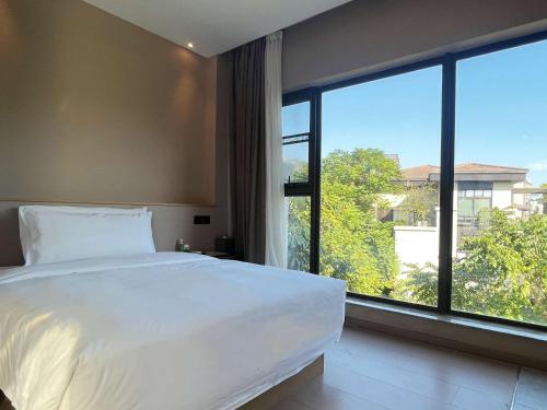 Katil atau katil-katil dalam bilik di Xiamen Lujiang Mingjia Hotel