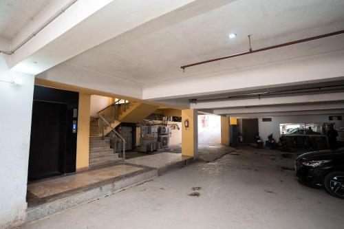an empty parking garage with a car parked in it at Hotel Radiance Courtyard in Varanasi