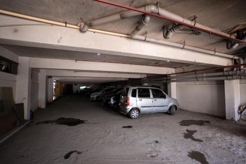 a parking garage with two cars parked in it at Hotel Radiance Courtyard in Varanasi