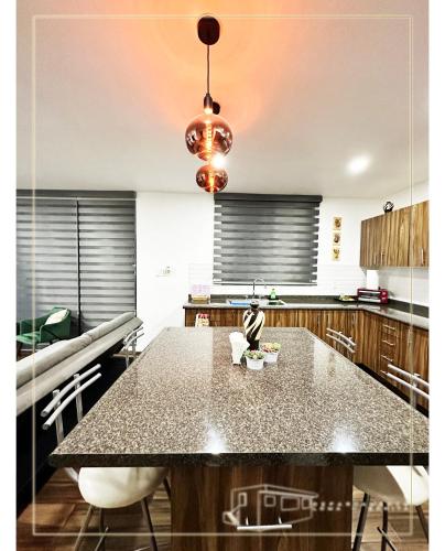 a kitchen with a large table with chairs at Departamento Loma-Bonita in Guadalajara