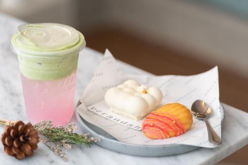 a table with a drink and a plate with a pastry at The Verandah - SHA Extra Plus in Ao Nang Beach