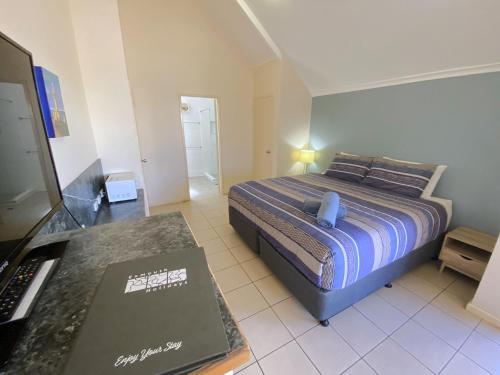a small bedroom with a bed and a desk at Osprey Holiday Village Unit 201 1 Bedroom in Exmouth