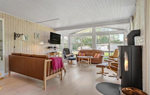 a living room filled with furniture and a fireplace at Holiday Home Strandholmen Millinge Xi in Millinge
