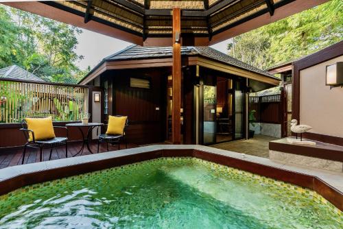 a swimming pool in the middle of a house at River Kwai Resotel in Sai Yok