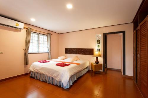 a bedroom with a bed with towels on it at Harry's Bungalows in Mae Nam