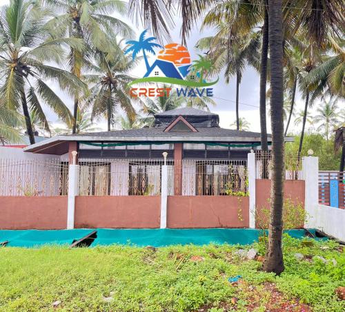 a resort with a sign that reads best wave at Crest wave beach home stay in Udupi