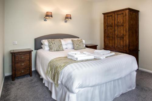a bedroom with a bed with towels on it at The Babbacombe Hotel in Torquay