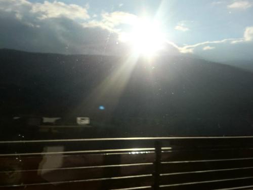 a sun is shining on a hill with the sky at Semmering Studio-Apartment in Semmering