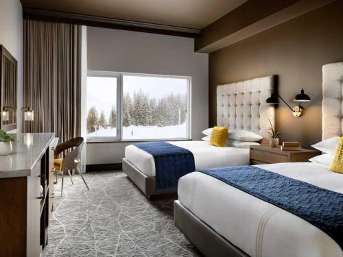 a hotel room with two beds and a window at The Josie Hotel, Autograph Collection in Rossland