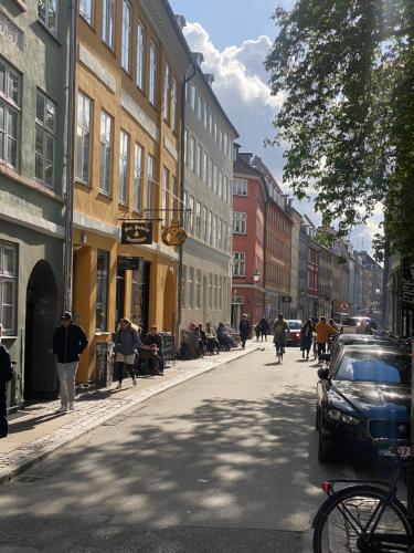 a city street with people walking down the street at Oldest bakery in Denmark 17 min from Airport 5 stars in Copenhagen