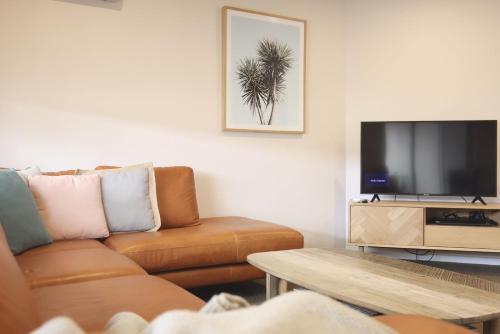 a living room with a couch and a flat screen tv at Guichen Villa 3 - Wi-Fi Pets welcome outside in Robe