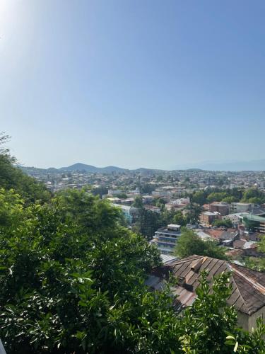 a view of a city with trees and buildings at Garden rooms in Kutaisi in Kutaisi