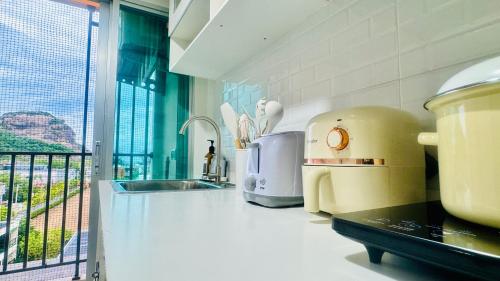 a kitchen with a counter top with a appliance at Sea&Mountain view,5 mins walk to famous beach with King size bed in Hua Hin