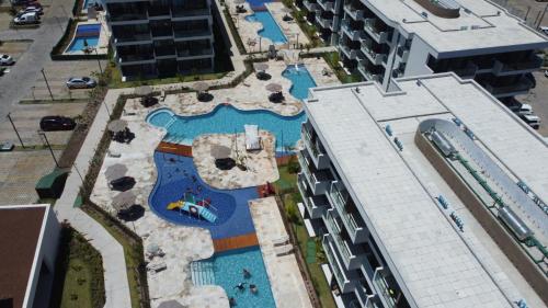 an overhead view of a swimming pool in a resort at Makia Beach experience Flat 115 A in Porto De Galinhas